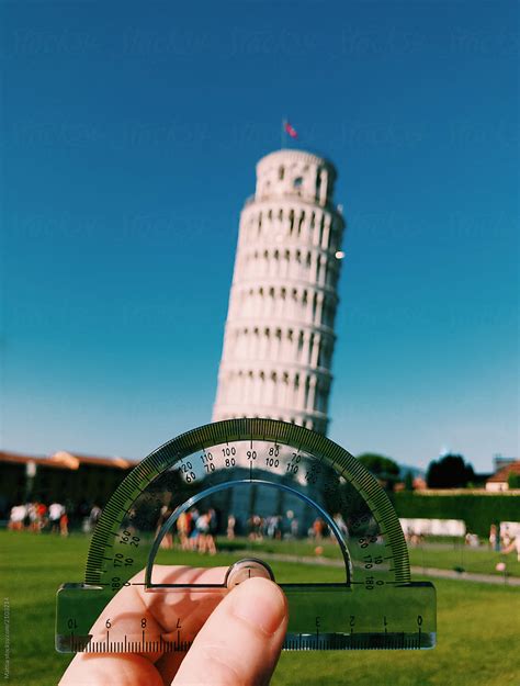 Man Using A Protractor To Measure The Angle Of The Leaning Tower Of