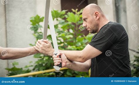 eskrima and kapap instructor demonstrates machete weapon fighting technique stock image