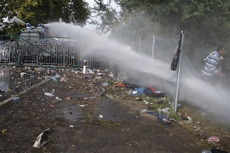 Hungary Riot Police Fire Tear Gas And Water Cannons At Refugees And Migrants At Border Photos