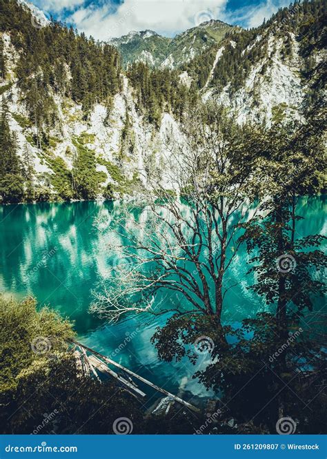 Vertical Of The Mesmerizing Turquoise Lake In Jiuzhaigou Valley Against