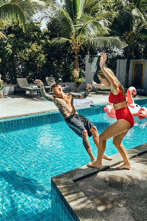 Maybe you would like to learn more about one of these? Woman Pushing Man Into Swimming Pool | Stocksy United ...