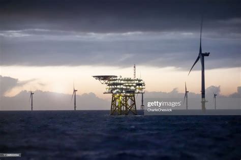 Offshore Platform Substation And Wind Farm In Sunset High Res Stock