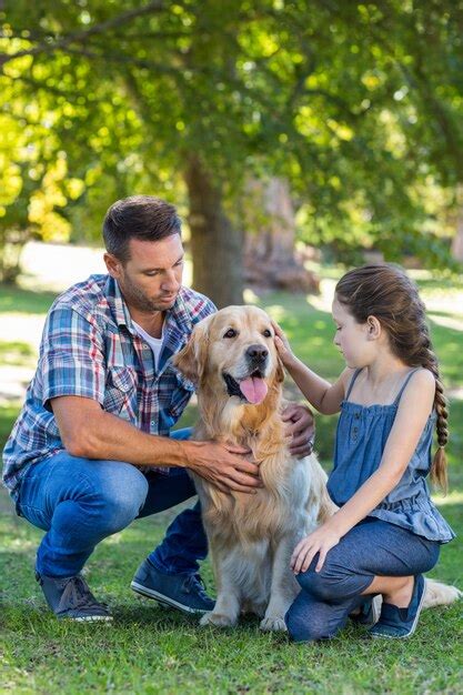 Padre E Hija Con Su Perro En El Parque Foto Premium