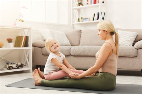 Mother And Daughter Doing Yoga Exercises At Home Stock Image Image Of