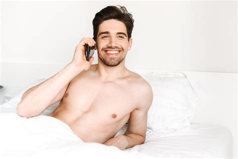 Premium Photo Smiling Shirtless Man Talking On Mobile Phone