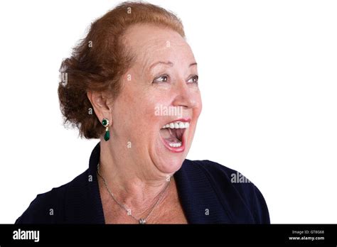 close up senior woman showing a surprised facial expression with mouth open and looking to the