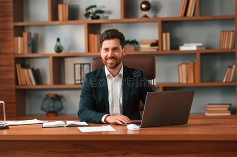 Using Laptop Businessman In Formal Clothes Is Working Indoors Stock