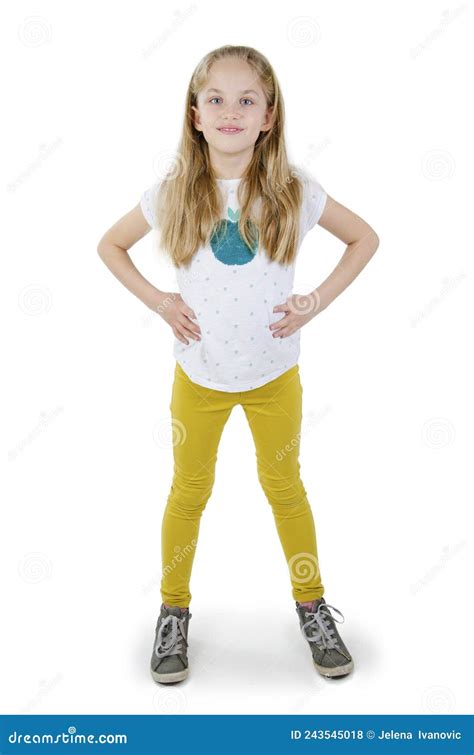 Portrait Of Happy Smiling Child Girl Standing With Hands On Hips Full