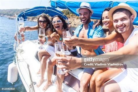 Friends Drinking Champagne On A Yacht Photos And Premium High Res