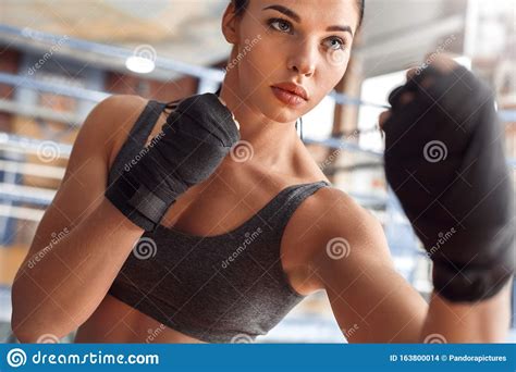 Boxing Woman Boxer With Bandage Around Hands Exercise Kick Near Ring