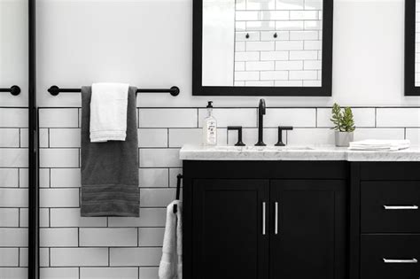 A black penny tile backsplash and gold shelves and a sleek white kitchen with black large scale tile backsplash that contrasts and stands out a lot. Custom black double vanity with Quartz countertop, Brizo ...
