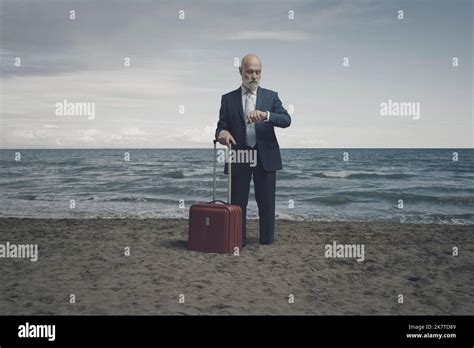 Traveling Businessman Waiting To Leave At The Beach And Checking The