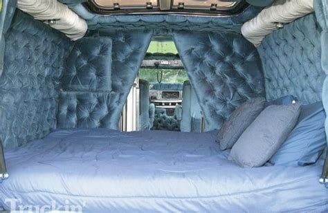 The Inside Of An Inflatable Bed With Blue Sheets And Pillows On Its Sides