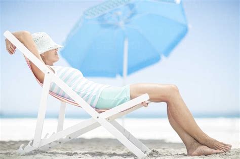 Woman On Beach Relaxing On A Beach Chair Stock Photo
