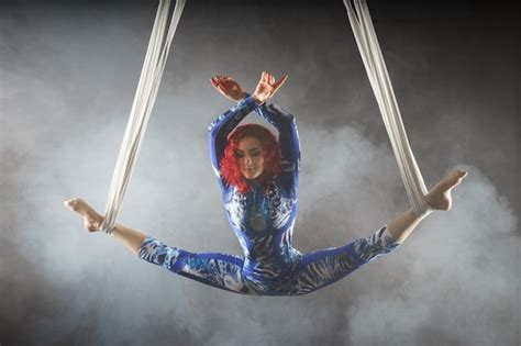 premium photo athletic sexy aerial circus artist with redhead in blue costume dancing in the