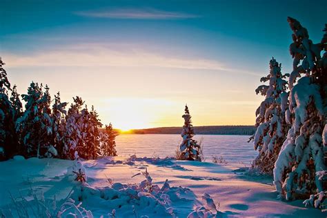 Northern Saskatchewan Lake And Snow Covered Forest During Winter Sunset