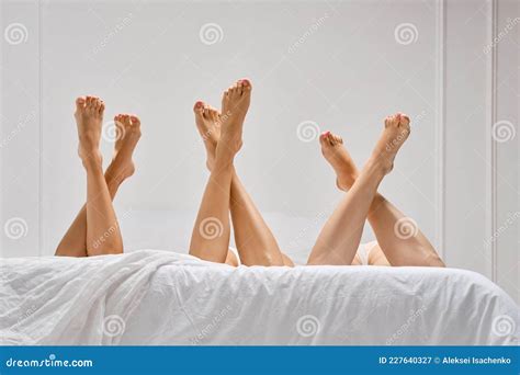 Low Angle View Of Three Pairs Female Legs In Bed Stock Image Image Of