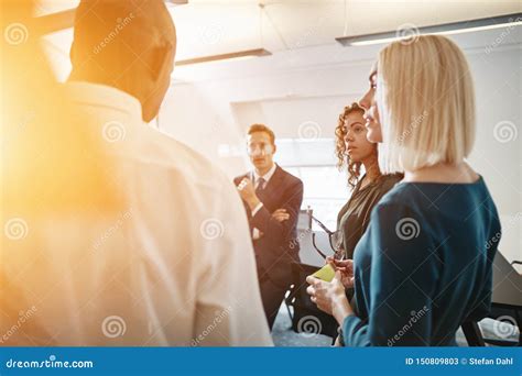 Diverse Businesspeople Talking Together In A Bright Modern Offic Stock