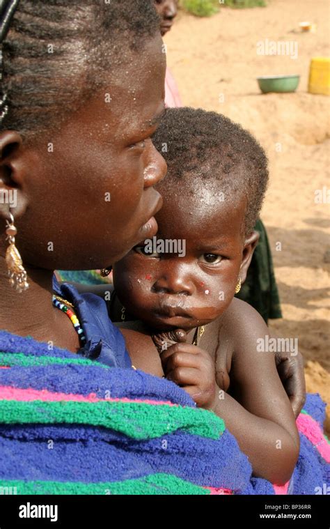 An African Woman Holds Her Baby In Burkina Faso West Africa Stock