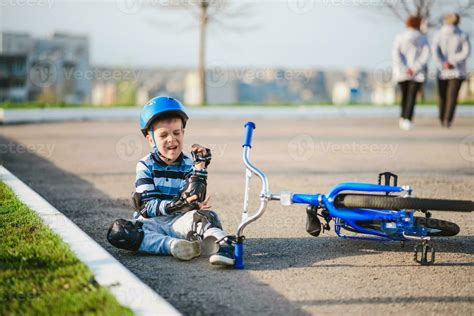 A Small Child Fell From A Bicycle Onto The Road Crying And Screaming