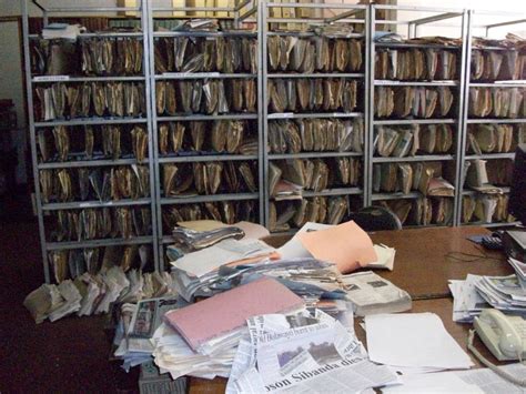 An Office Filled With Lots Of Files And Papers