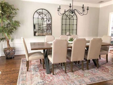 A Dining Room Table And Chairs With A Rug On The Floor