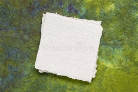 Small Square Sheet Of Blank White Paper Against Marbled Paper Stock