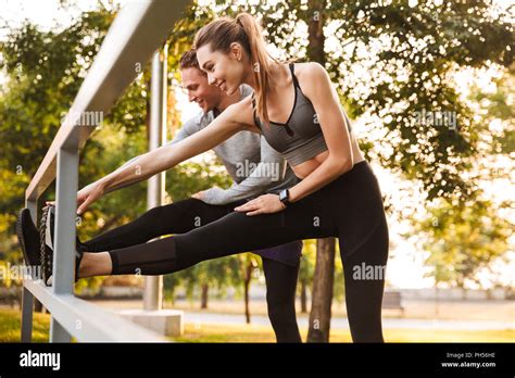Image Of Strong Fitness Sport Loving Couple Friends In Park Outdoors Make Stretching Exercises