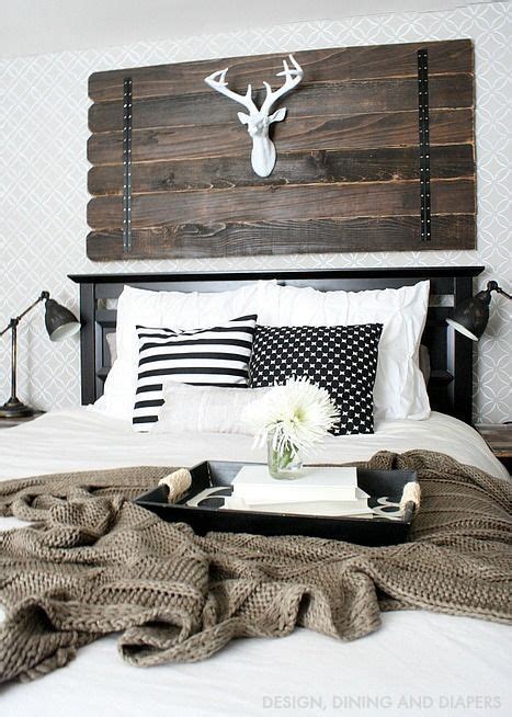 Wake up those bedroom walls with some dreamy decorating ideas. Rustic white bedroom inspiration with reclaimed wood wall decor, deer head, white bedding, and ...