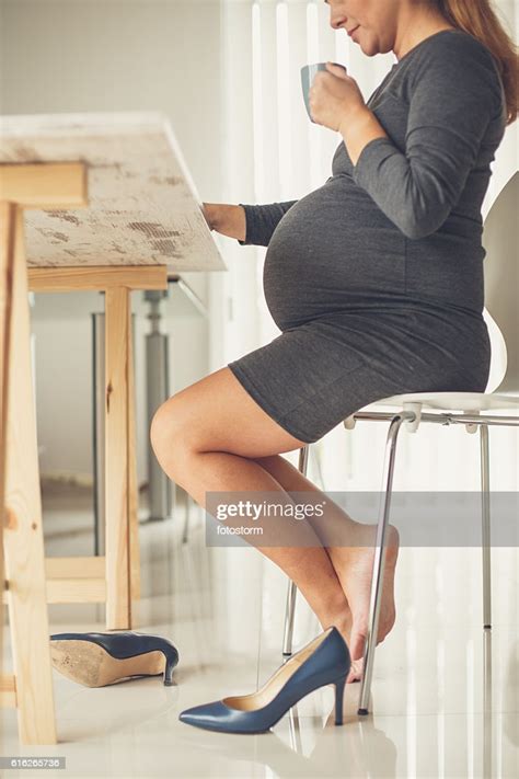 Barefoot Pregnant Business Woman In Office Drinking Coffee Photo
