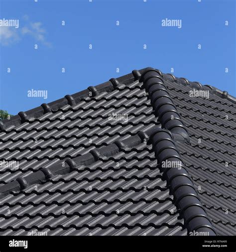 Black Tiles Roof On A New House With Blue Sky Stock Photo Alamy