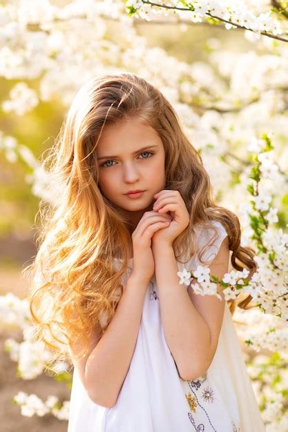 Premium Photo A Young Girl In A Flower Garden