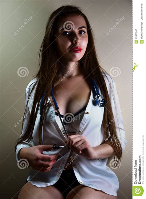Young Nurse Girl Sitting With Stethoscope Stock Image