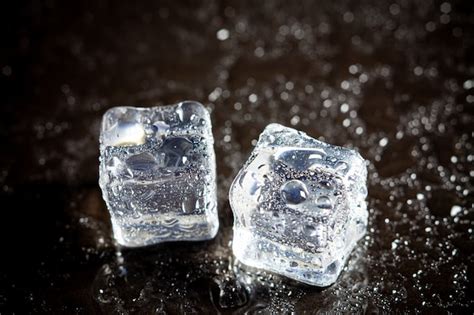 Premium Photo Ice Cubes Reflection On Black Table