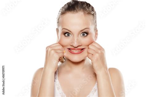 Young Woman Pinching Her Cheeks And Pretend Smile Buy This Stock