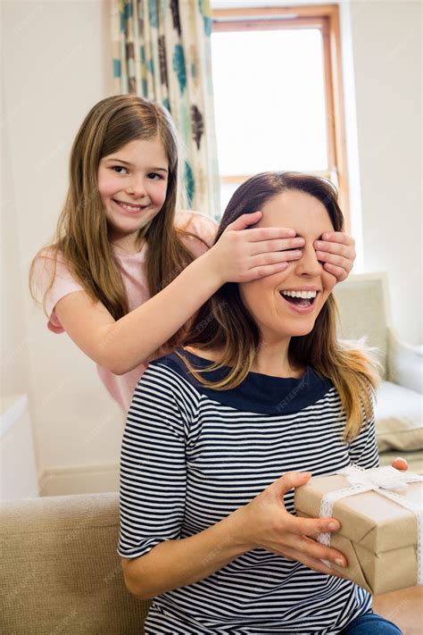 Free Photo Daughter Covering Her Mother Eyes In Living Room