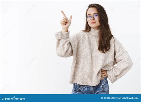Determined And Assertive Self Assured Good Looking Woman In Glasses And Sweater Pointing At