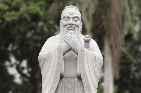 Statue Of Confucius Stone Statue Of Confucius With Blurred Trees