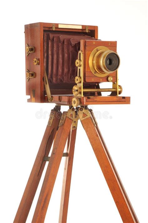 Very Old Camera On A Wooden Tripod On A White Background Sponsored