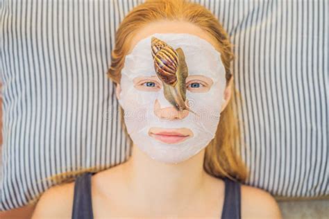 Young Woman Makes A Face Mask With Snail Mucus Snail Crawling On A