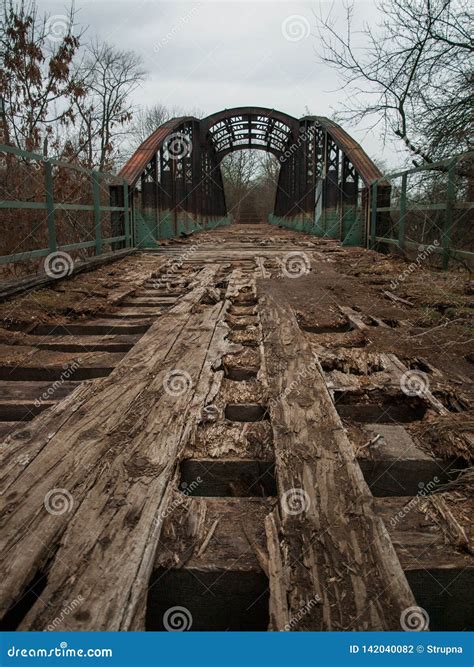 Crumbling Bridge With Broken Wooden Planks And Rusty Steel Stock Photo