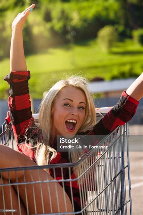 Happy Young Blond Woman In A Shopping Cart Stock Photo Download Image