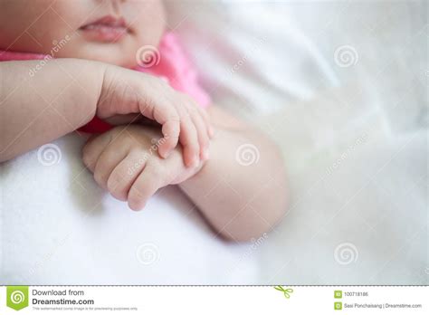 Newborn Baby Girl Hands Holding While She Sleeping Stock Photo Image