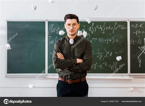 Crumpled Paper Balls Flying Male Teacher Arms Crossed Classroom