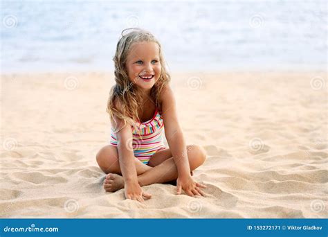 Adorable Little Girl Relax On Sandy Beach In Summer Vacation Stock