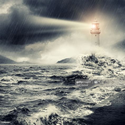 Composite image of a lighthouse beacon shining with stormy weather
