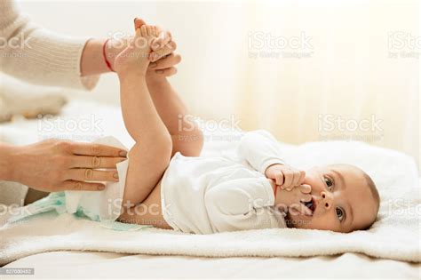 Cute Baby In Bedroom Getting Diaper Changed Stock Photo Download