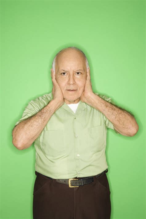 Man with hands over ears. stock image. Image of receding - 2037601