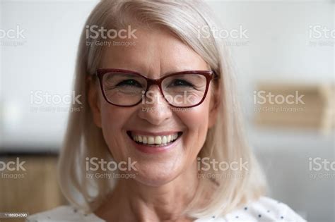 Happy Older Woman Looking At Camera At Home Closeup Portrait Stock