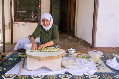 turkish woman makes a traditional national dish a baked flat pancake gozleme editorial